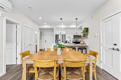 a kitchen and dining room with a wooden table and chairs at Luxe 3BR Golden Hideaway Top Floor, Balcony & BBQ in Golden