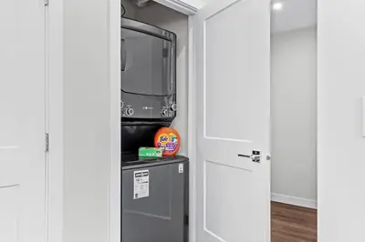 a small refrigerator with a tv in a room at Scenic Riverstone 2BR w/ Balcony + BBQ, Sleeps 6! in Golden
