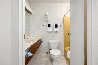 a bathroom with a toilet and a sink at Charming 1BR Near DT Kimberley: Pool, Hot Tub, Gym in Kimberley