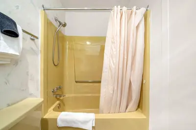 a bathroom with a shower with a shower curtain at Kimberley Escape: 1BR+Studio w/ Hot Tub, Pool, BBQ in Kimberley