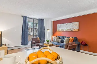 a living room with a basket of oranges on a table at Stampede Modern downtown Condo Spacious 2BR in Calgary