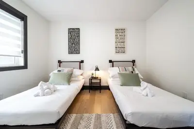 two beds with stuffed animals on them in a room at Luxury Sleeps 10 King bed Jacuzzi 10 Min to West Edmonton Mall in Edmonton