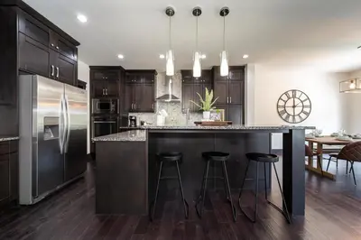 a kitchen with a large island with bar stools at Luxury Sleeps 10 King bed Jacuzzi 10 Min to West Edmonton Mall in Edmonton