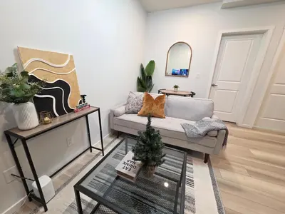 a living room with a couch and a christmas tree at Amaville Suites - One Bedroom in West Edmonton in Edmonton