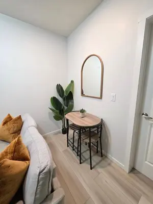 a living room with a table and a couch at Amaville Suites - One Bedroom in West Edmonton in Edmonton