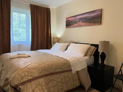 a bedroom with a large bed with white pillows at Modern Vacation Home Near West Edmonton Mall, Transit Center & LRT - 3BR in Edmonton