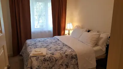 a bedroom with a large bed with a window at Modern Vacation Home Near West Edmonton Mall, Transit Center & LRT - 3BR in Edmonton