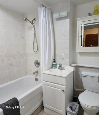 a bathroom with a tub and a toilet and a sink at Wallace getaway in Delta