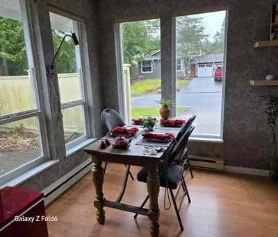 a table in a living room with windows at Wallace getaway in Delta