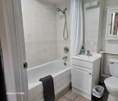 a bathroom with a tub and a sink and a toilet at Wallace getaway in Delta