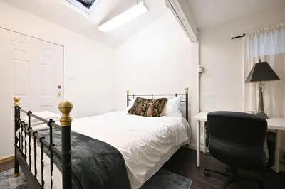a bedroom with a bed and a desk and a chair at Vancouver UBC 2BD Suite in Vancouver