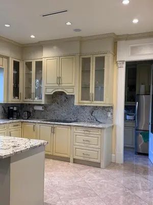 a kitchen with yellow cabinets and a refrigerator at Sweet Graceful Home Queen size bedroom for 2 Guests in Richmond