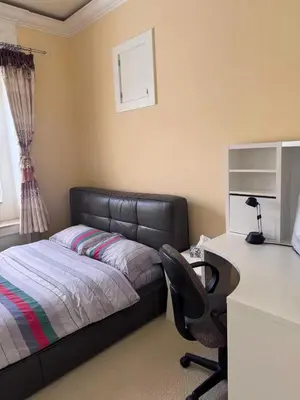 a bedroom with a bed and a desk and a chair at Sweet Graceful Home Queen size bedroom for 2 Guests in Richmond