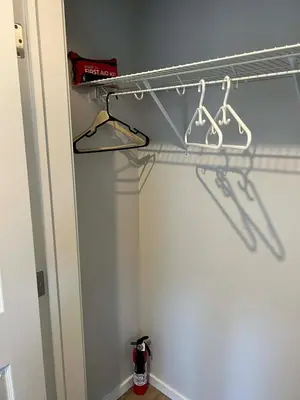 a closet with two hangers and a shelf at Northside Dream Home in Edmonton