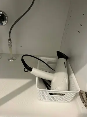 a kitchen counter with a hair dryer in a holder at Northside Dream Home in Edmonton