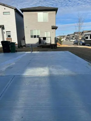 a concrete parking lot in front of a house at Northside Dream Home in Edmonton