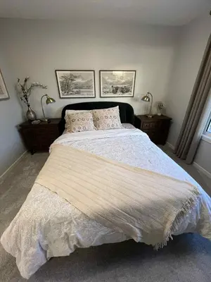 a bedroom with a large bed with two night stands at Northside Dream Home in Edmonton