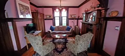 a living room with a table and a couch at Rosewood in New Westminster