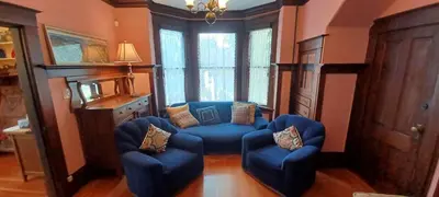 a living room with blue chairs and a couch at Rosewood in New Westminster