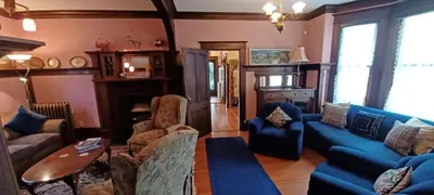 a living room with a blue couch and chairs at Rosewood in New Westminster