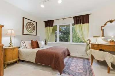 a bedroom with a bed and a window at Entire Spanish Style Villa 5 Bedrooms near Ocean in West Vancouver
