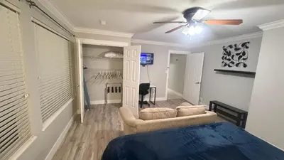 a bedroom with a bed and a ceiling fan at J & J Dream Villa Ltd in Abbotsford
