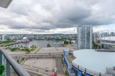 a view of a river in a city with buildings at Cozy Condo in Prime Location with Jacuzzi Pool & Sauna in Vancouver