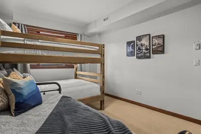 a bedroom with two bunk beds in a room at Heart of Canmore Condo managed by Little Sister Getaways in Canmore