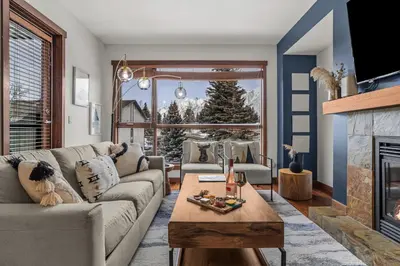 a living room with a couch and a fireplace at Heart of Canmore Condo managed by Little Sister Getaways in Canmore