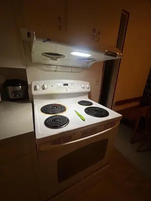 a white stove top oven in a kitchen at Airport Vancouver Private Rooms - Transit at Doorstep, Free Parking & Fast Wi-Fi in Vancouver