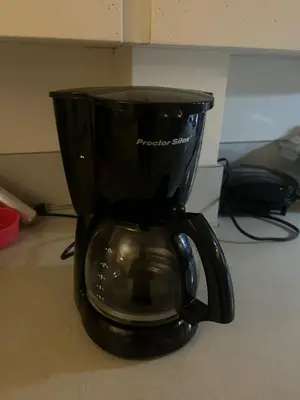 a black coffee maker sitting on a counter at Airport Vancouver Private Rooms - Transit at Doorstep, Free Parking & Fast Wi-Fi in Vancouver