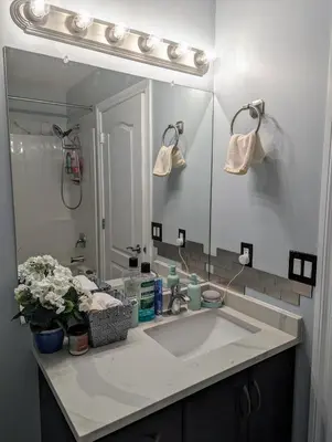 a bathroom with a sink and a large mirror at The Love Home Stay in Edmonton