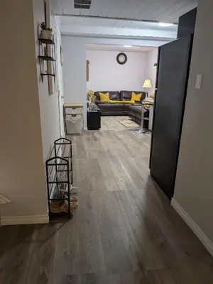 a hallway with a living room with a couch at The Love Home Stay in Edmonton