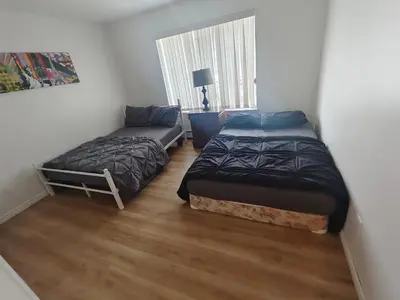 a bedroom with two beds and a window at Vancouver Private Rooms - Free Parking, Fast Wi-Fi, Easy Transit - 15 mins Downtown & 11 mins Airport in Vancouver