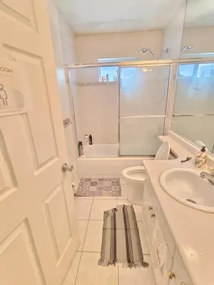 a white bathroom with a toilet and a sink at Vancouver Private Rooms - Free Parking, Fast Wi-Fi, Easy Transit - 15 mins Downtown & 11 mins Airport in Vancouver