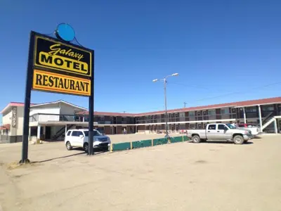 a motel sign in front of a parking lot at Galaxy Motel in St. Paul