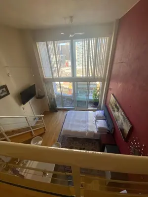 a living room with a bed and a large window at 933 seymour at vancouver downtown in Vancouver
