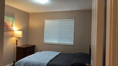 a bedroom with a bed and a window at Surrey- Delta Budget Guest House - Private Rooms & Suites, Free Parking & Fast Wi-Fi in Surrey