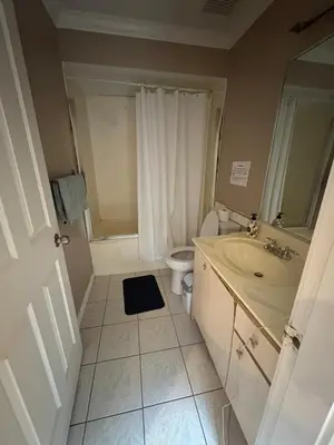 a bathroom with a sink and a toilet at Surrey- Delta Budget Guest House - Private Rooms & Suites, Free Parking & Fast Wi-Fi in Surrey
