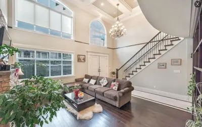 a living room with a couch and a staircase at Vancouver Burnaby Villa 44 in Burnaby