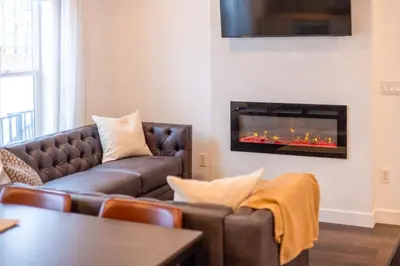 a living room with a couch and a fireplace at Peaks & Pines by Fernie Central Reservations in Fernie