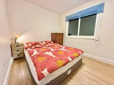 a bedroom with a bed and a window in it at Private Guest Suite, Two Parking Spaces in Maple Ridge District Municipality