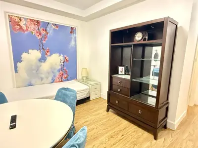 a living room with a table and a bedroom at Private Guest Suite, One Parking Space in Maple Ridge District Municipality