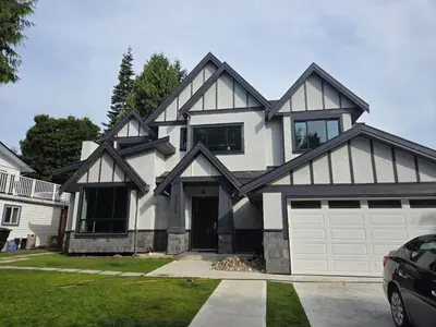 a white and black house with a garage at Luxury Suite in New Villa in Surrey