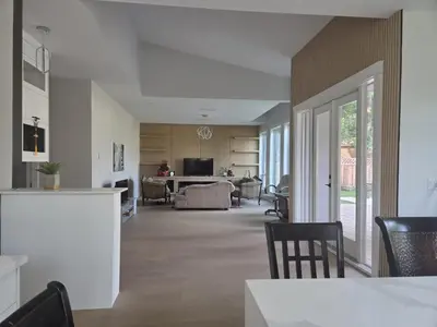 a living room with a kitchen and a dining room at Luxury Suite in New Villa in Surrey