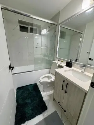 a bathroom with a toilet and a sink and a shower at Comfort 2 BR Vancouver! in Vancouver