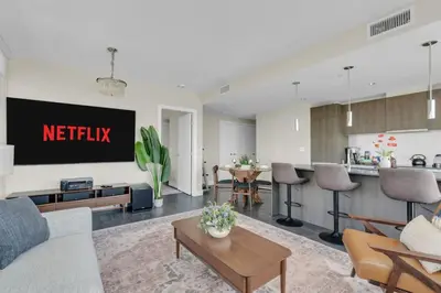 a living room with a tv and a kitchen at 1409 Guardian South in Calgary