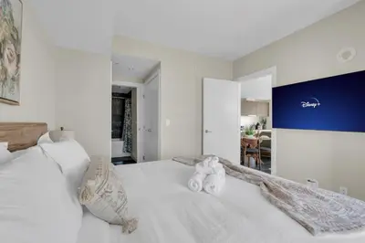 a white bed with two stuffed animals sitting on it at 1409 Guardian South in Calgary