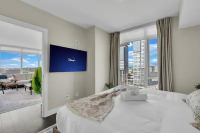 a bedroom with a large bed and a large window at 1409 Guardian South in Calgary
