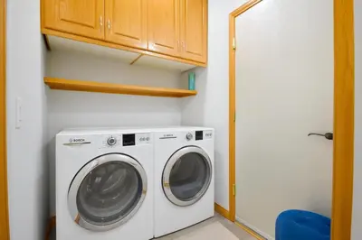 a washer and dryer in a small room at Shiraz Place in Calgary